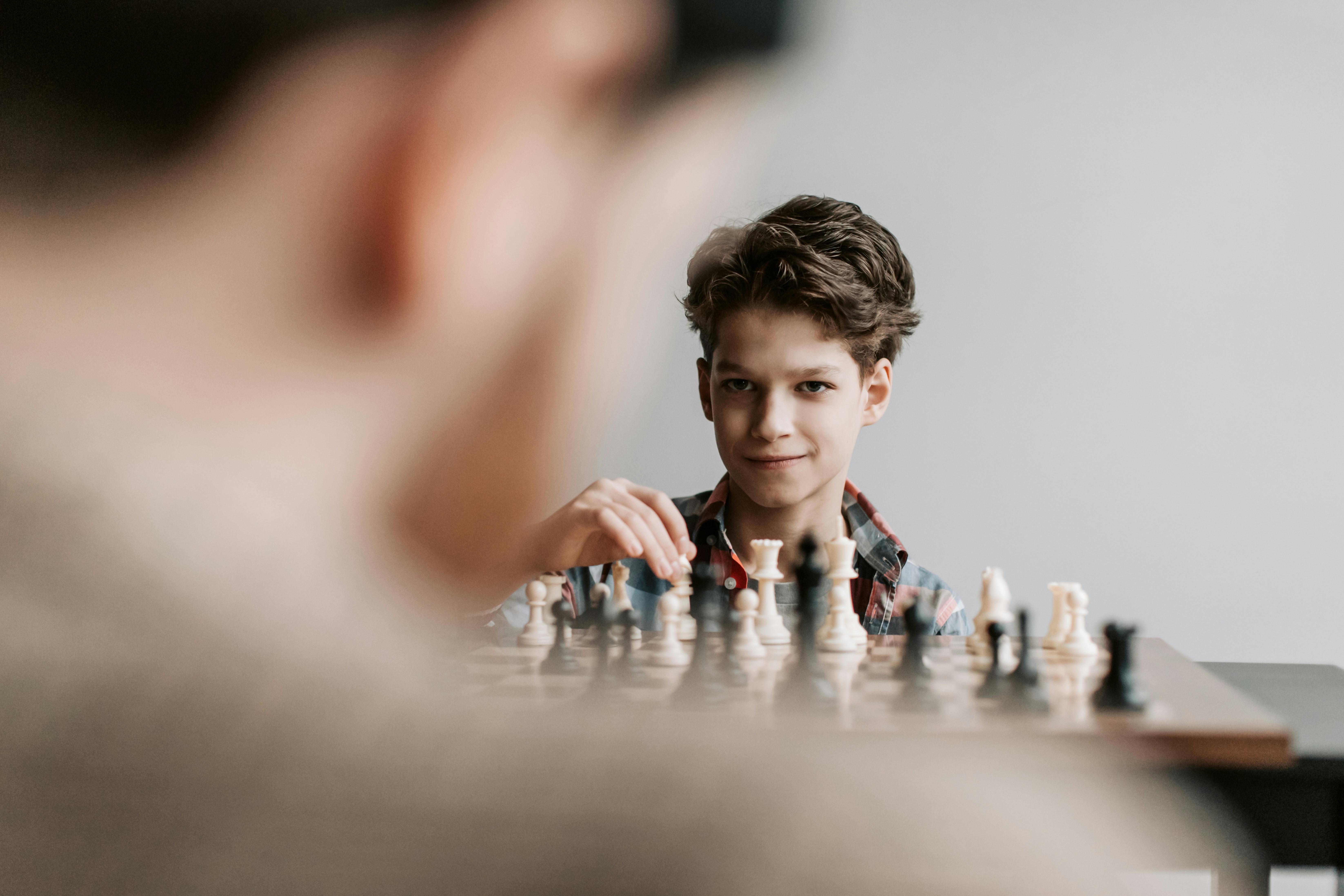a kid playing chess