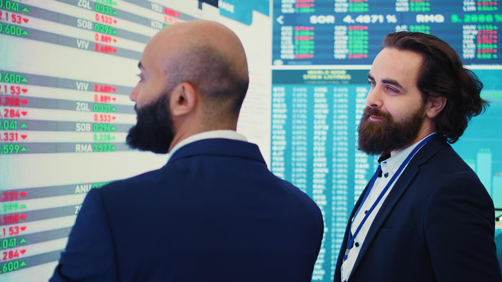 2 man looking at a stock chart