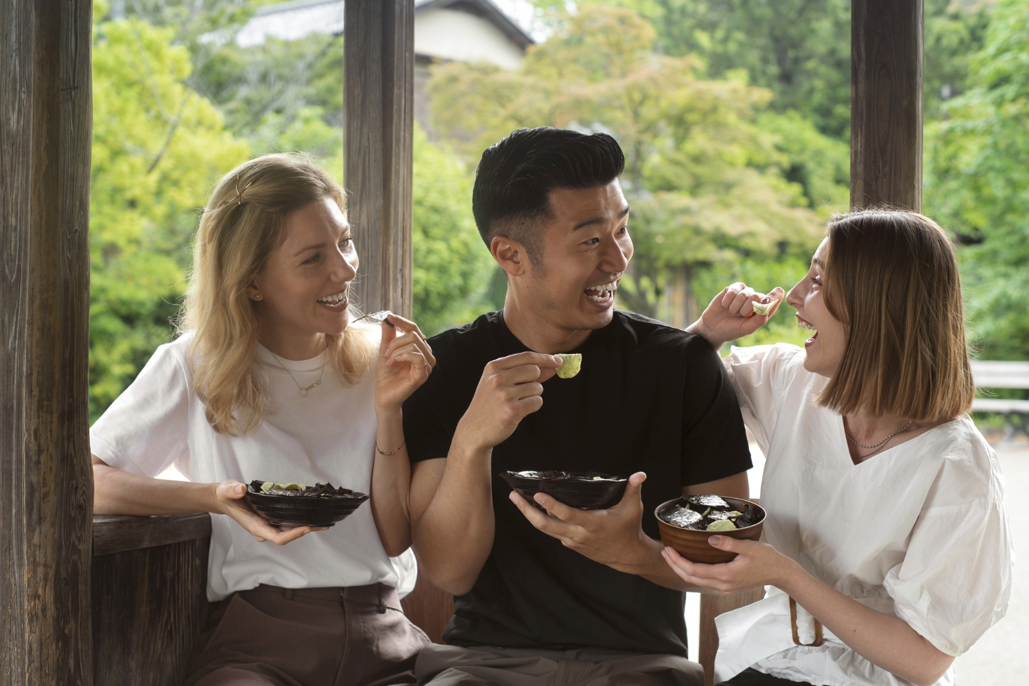 3 people talking to each other while eating