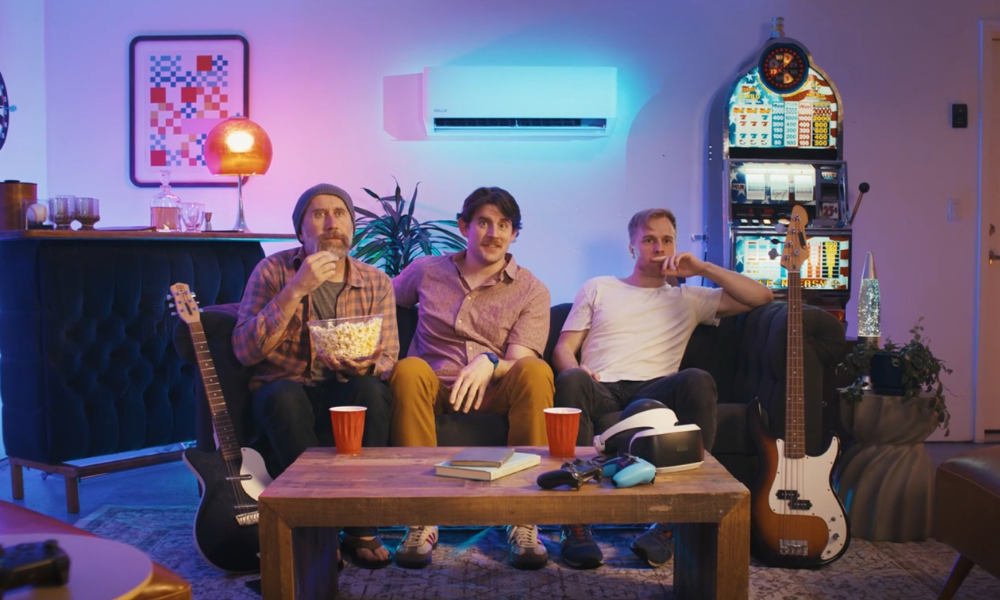 3 men sitting on a coach