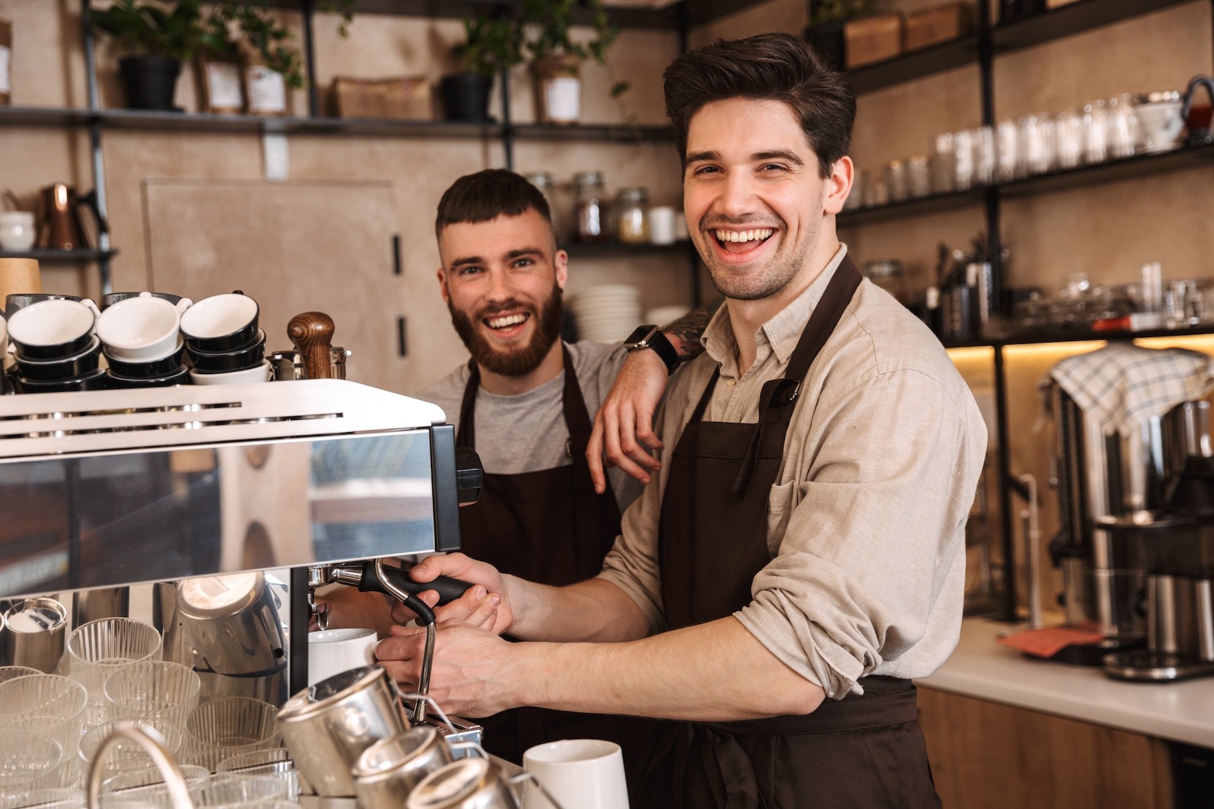 6 Reasons Food Businesses Need to Embrace Digital Transformation - two baristas smiling at camera while making coffee
