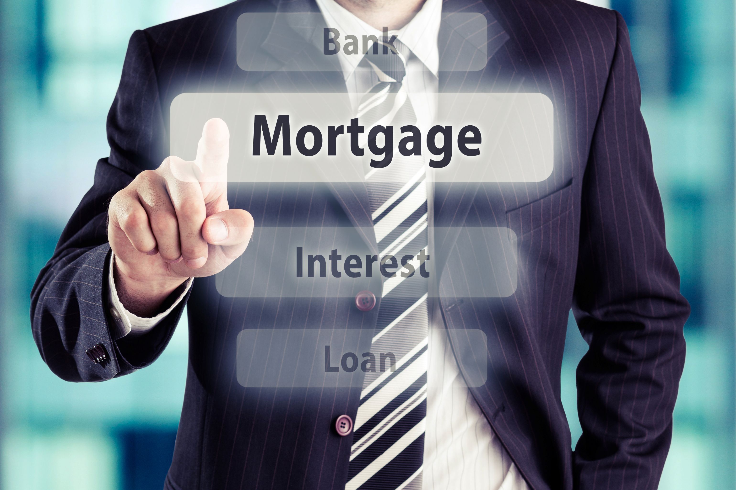 Concept image for how to buy a mortgage broker - man's torso in suit he points toward camera and imposed buttons of mortgage, bank, interest and loan appear - the mortgage button is larger and his finger is at it