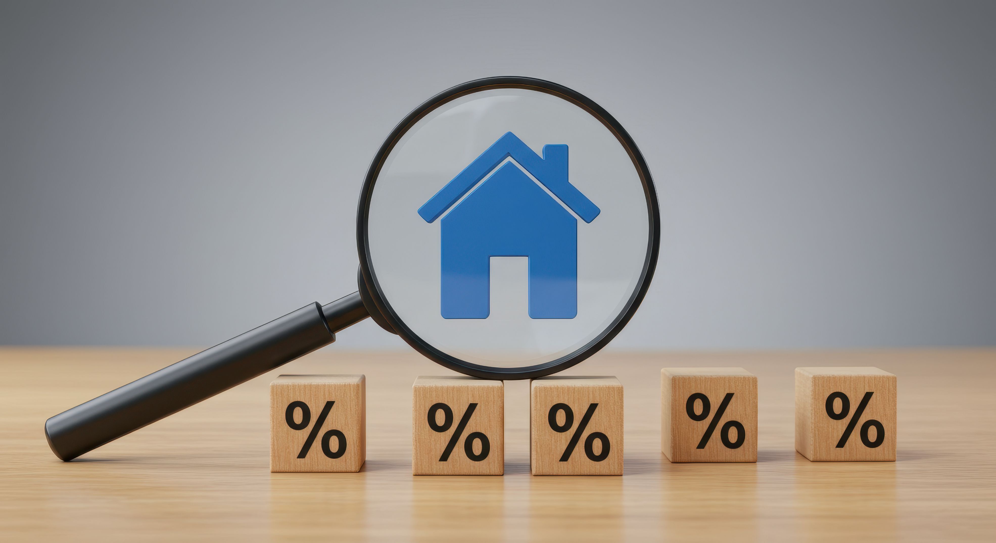 Magnifying glass with a home icon on top of 5 wooden blocks printed with the % symbol