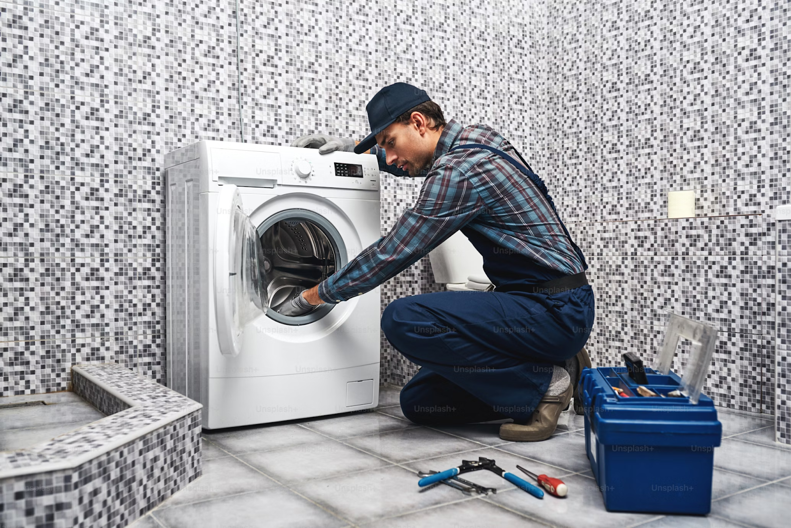A man repairing a washing machine