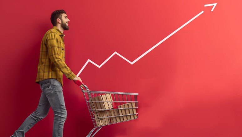 A man with a shopping cart and a graph behind him