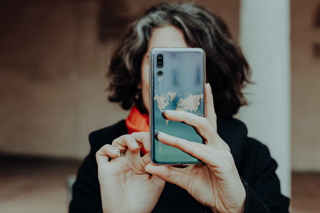 A woman holding up a phone upclose