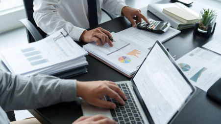 CPA Insights- Smart Strategies for Year-End Tax Planning Cropped shot of to peoples hands working at desk