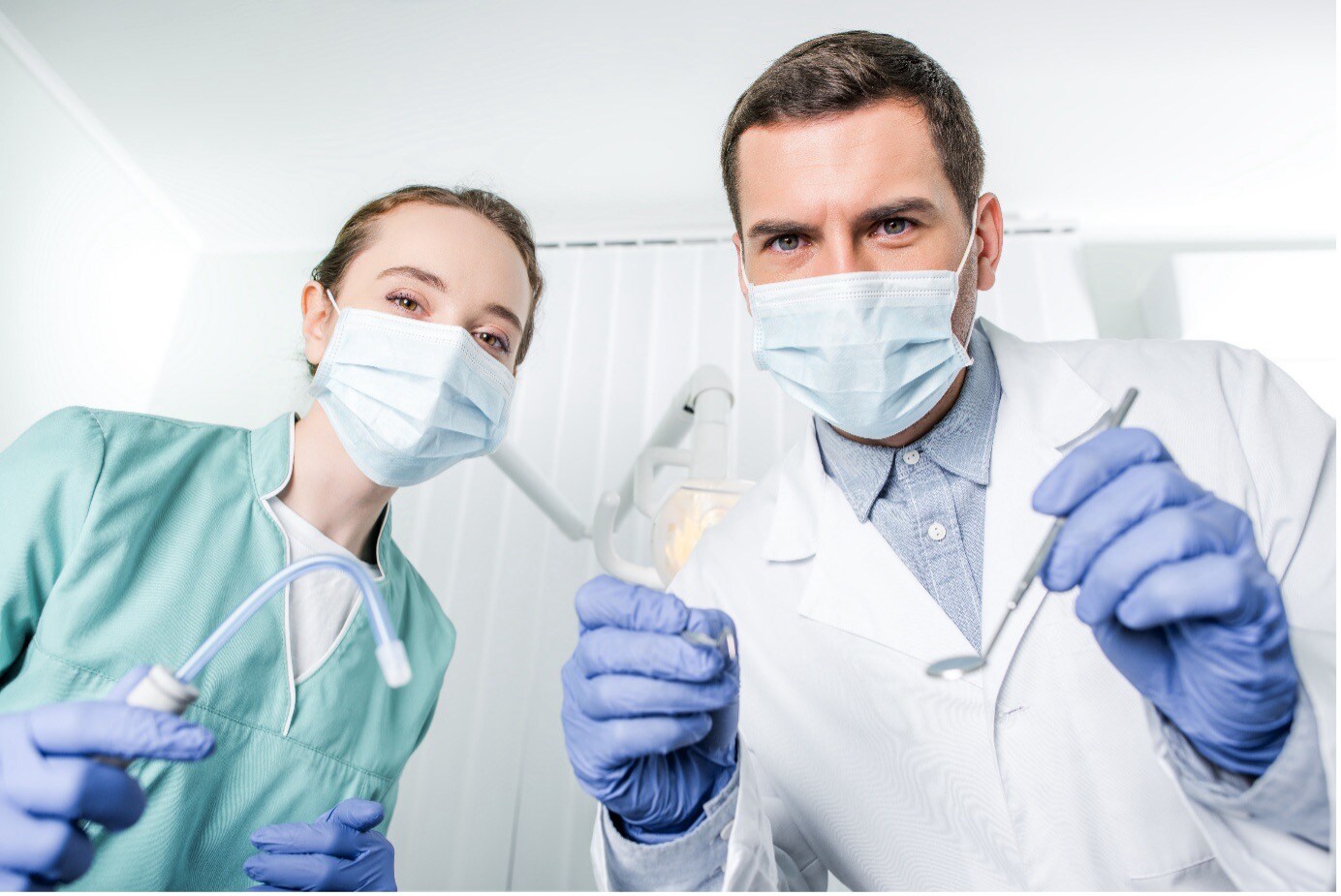 Photo of Emergency Dentist and Dental Nurse taken from the patient perspective looking up