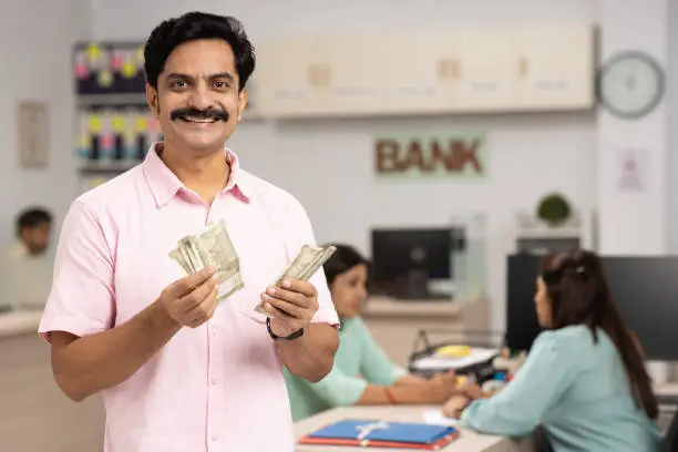 Picture of a guy holding moneys in both hands