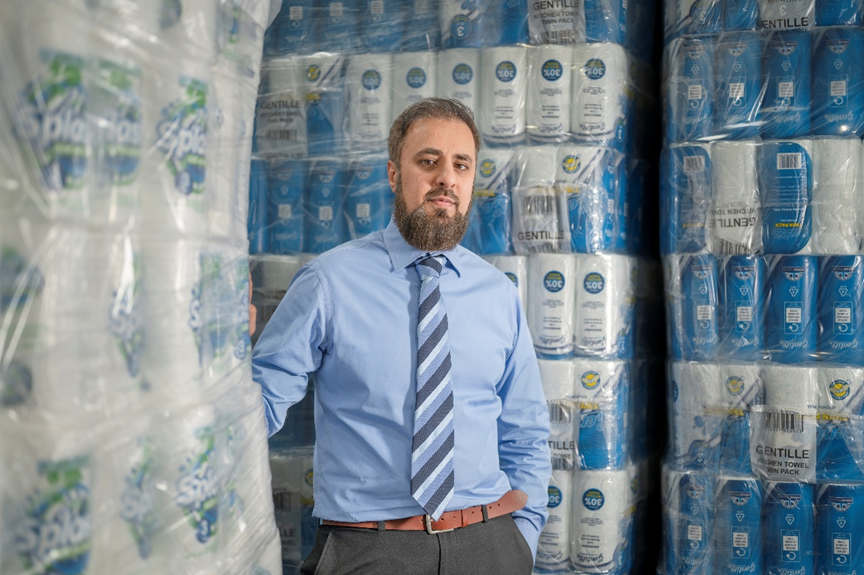 A person standing in a room with stacks of toilet paper
AI-generated content may be incorrect.