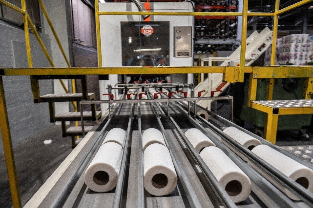 Rolls of paper on a conveyor belt
AI-generated content may be incorrect.