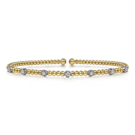 How to Style Bangle Bracelets - close up photo of a stylish gold bracelet