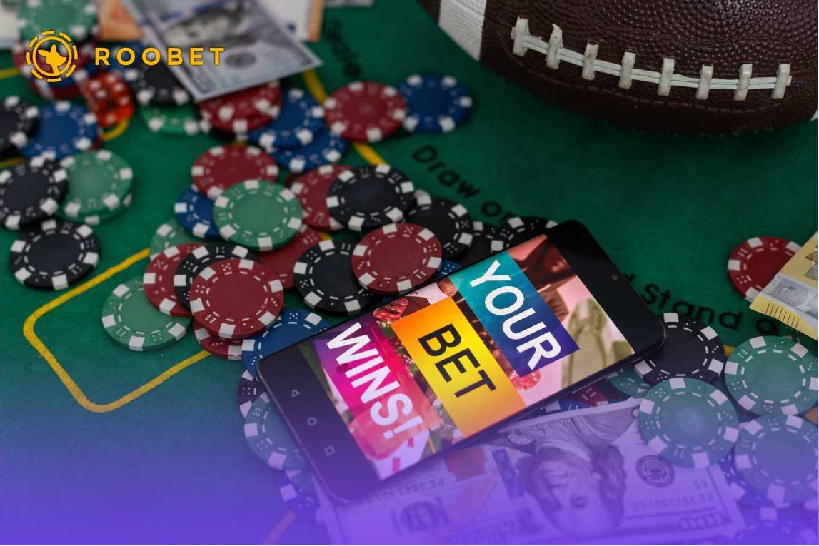 Money, chips, a phone, and a football on a casino table