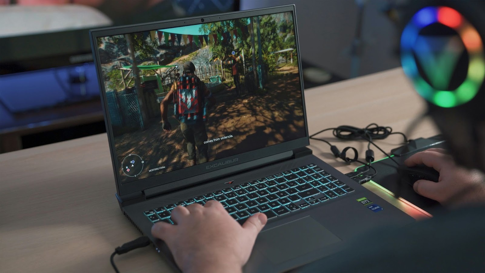 Person playing a video game on a gaming laptop with a backlit keyboard and a headset visible.