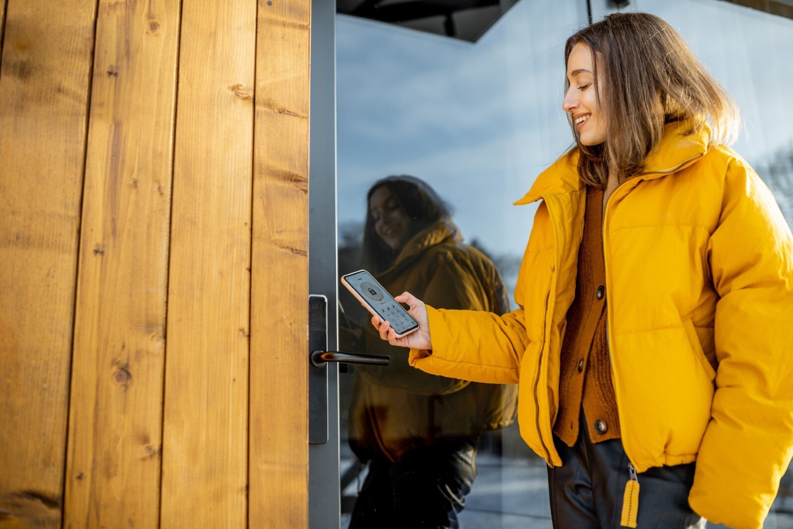 Image of woman using keyless lock smarthome key on front door