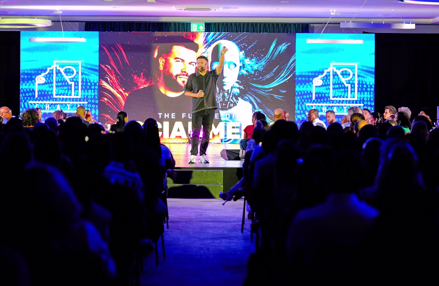 Speaker presenting on stage to an audience