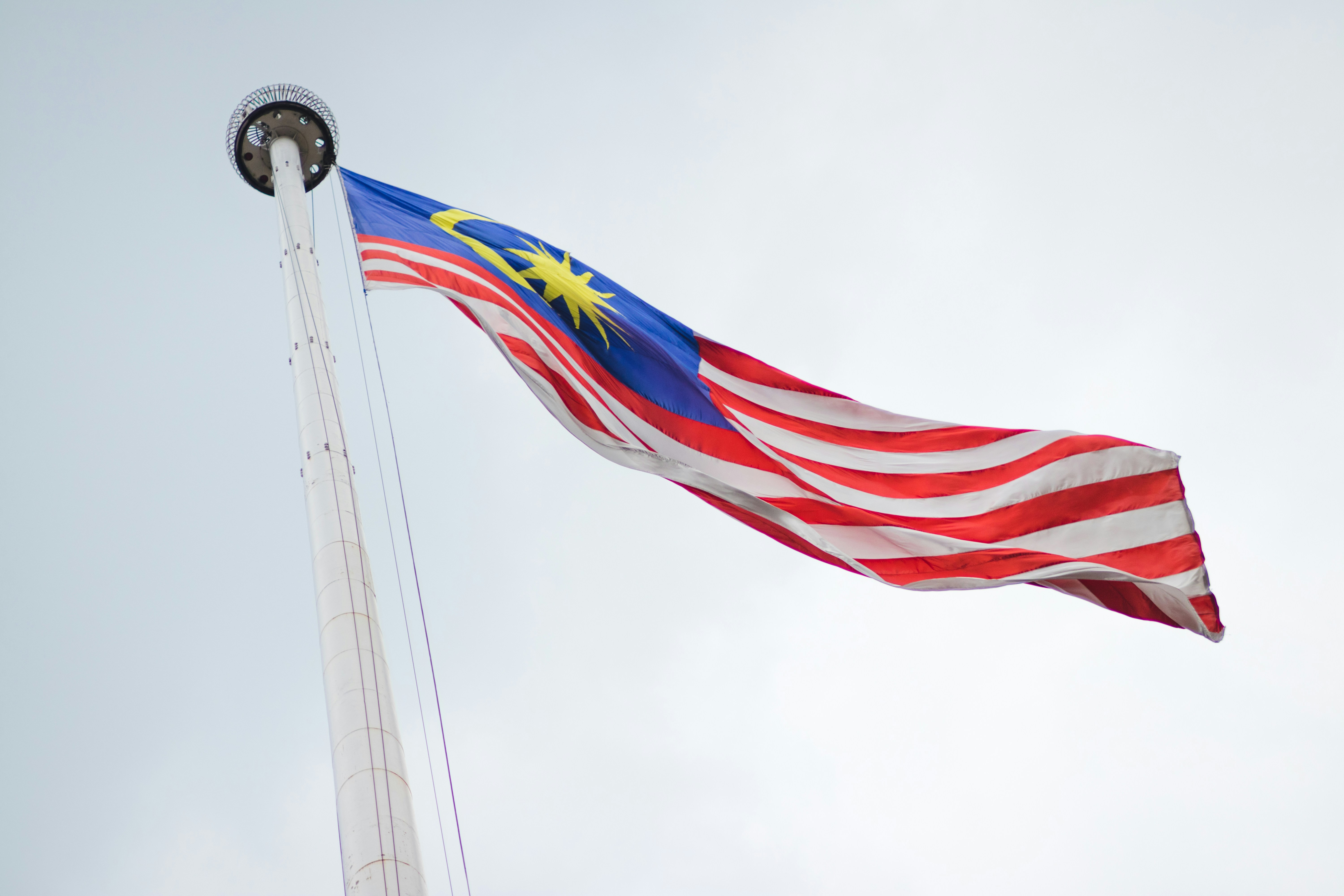 The Malaysian Flag Waving on a Pole