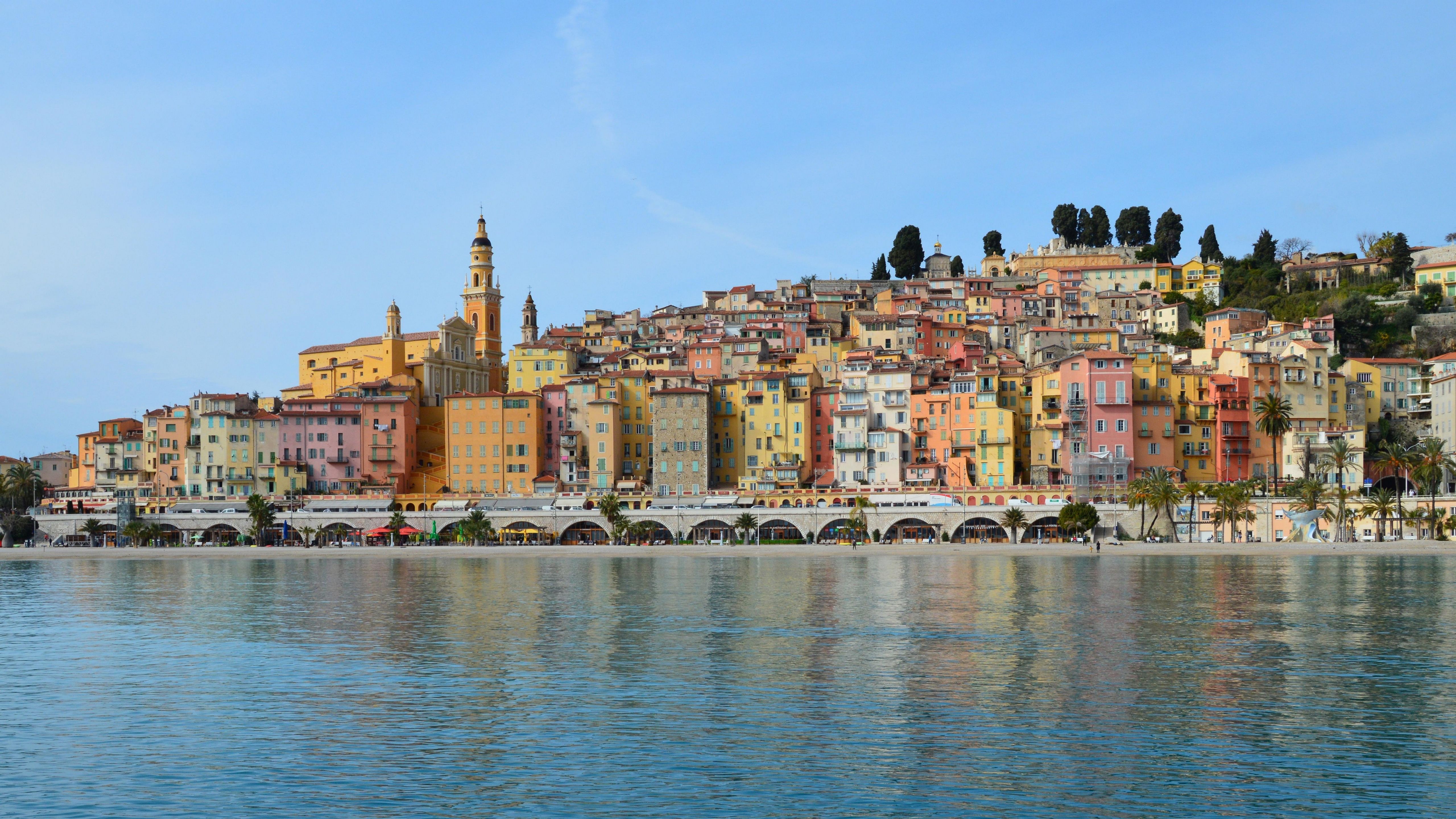 Vibrant townscape of Menton with colorful buildings along the sparkling coast of the French Riviera.