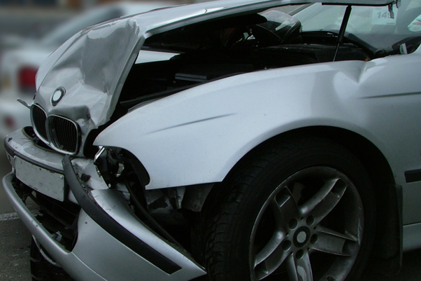 A picture of a front hood of a car wrecked