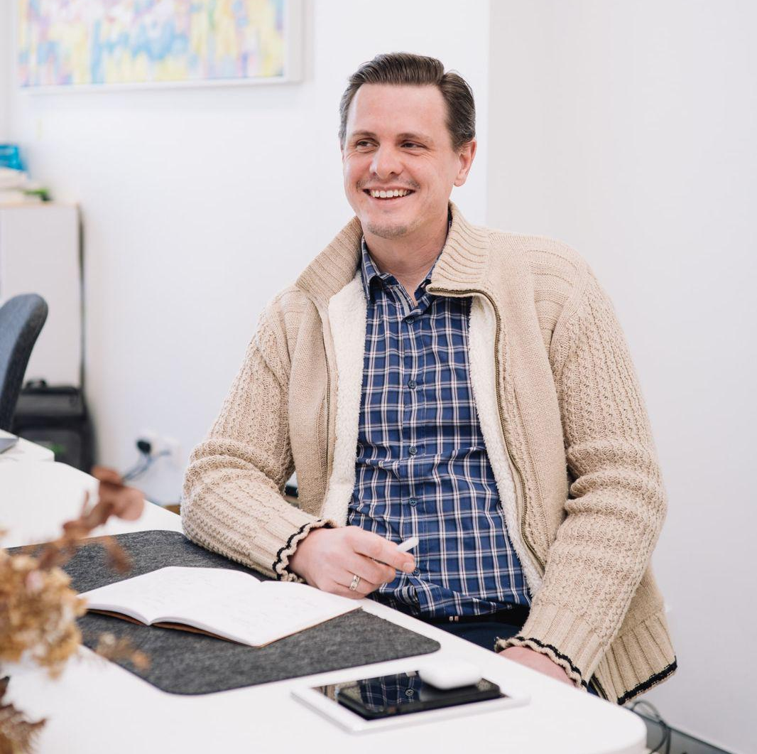 a man smiling in an office