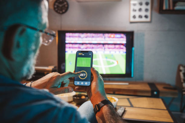 a man using a betting app on phone