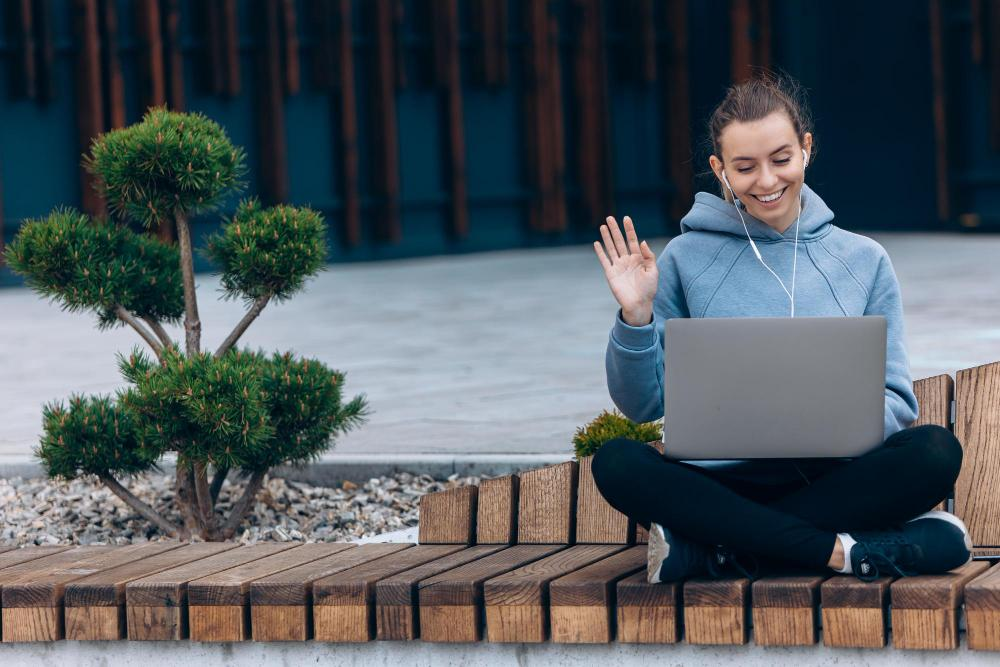 a woman looking at a laptop smiling