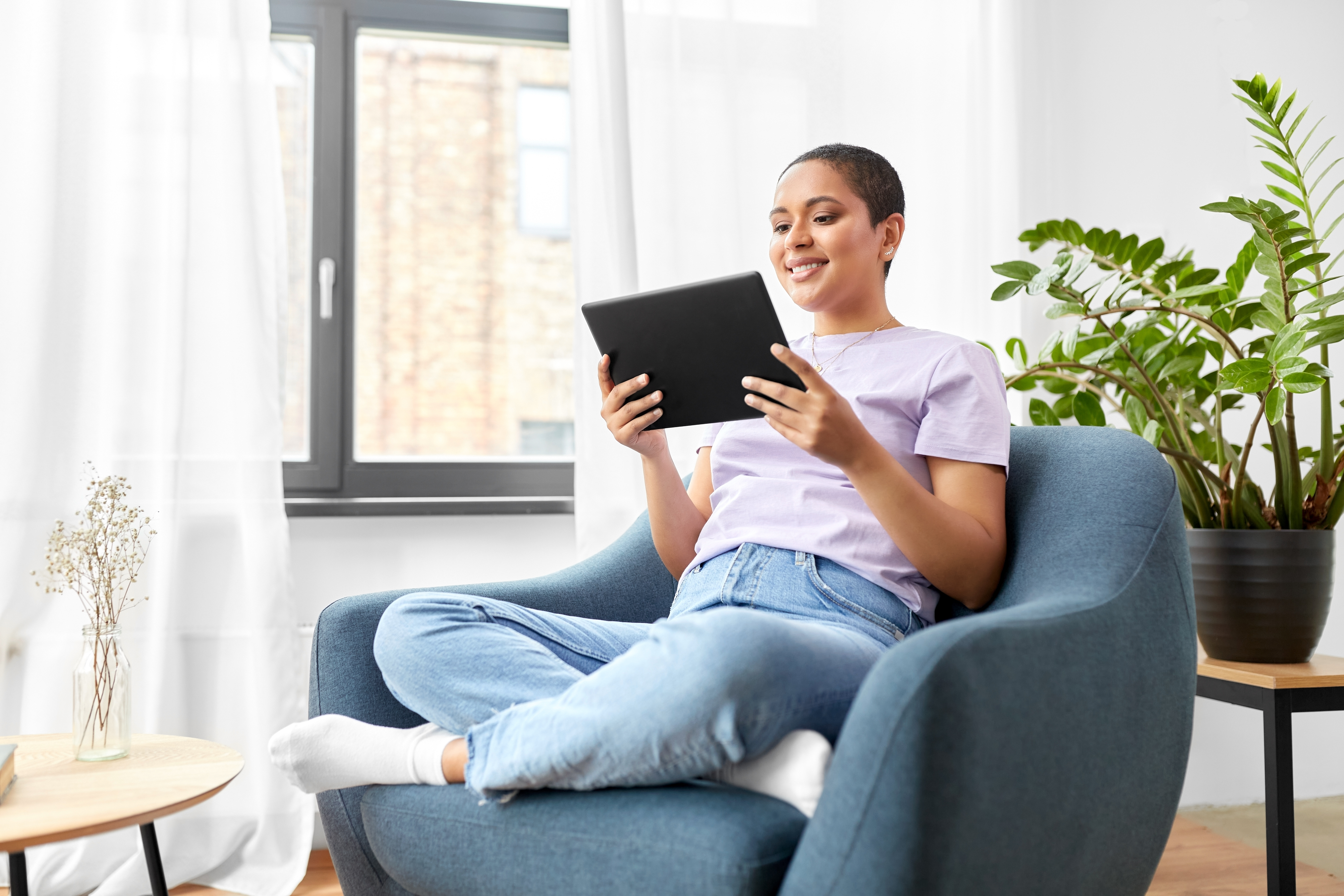 A relaxed property owner managing their vacation rental business from a tablet.