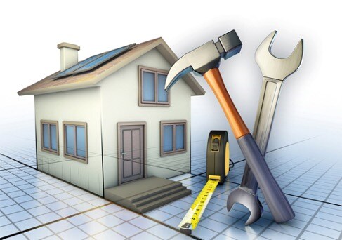 Computer illustration of house standing on plans with tools in foreground