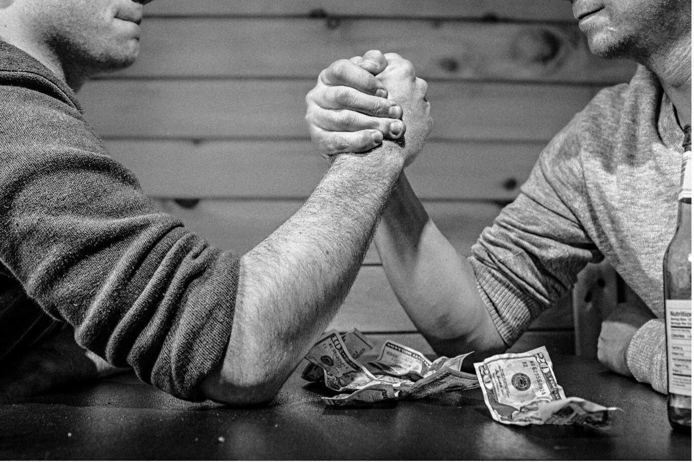 black and white photo of two men arm wrestling