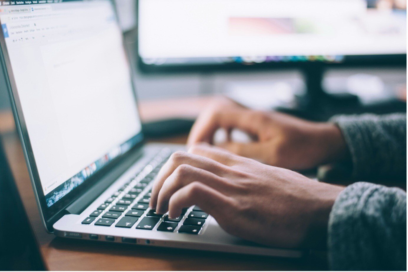 close up photo of hands typing on keyboard