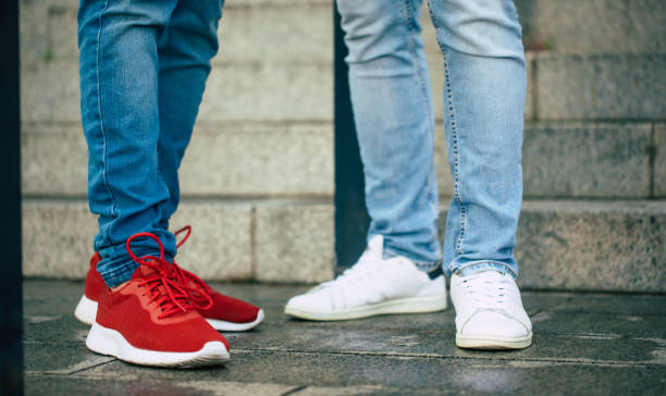 Close up photos of Men’s Size 15 Sneakers being worn one red pair one white pair