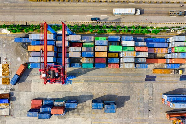 shipping containers stack up in a port