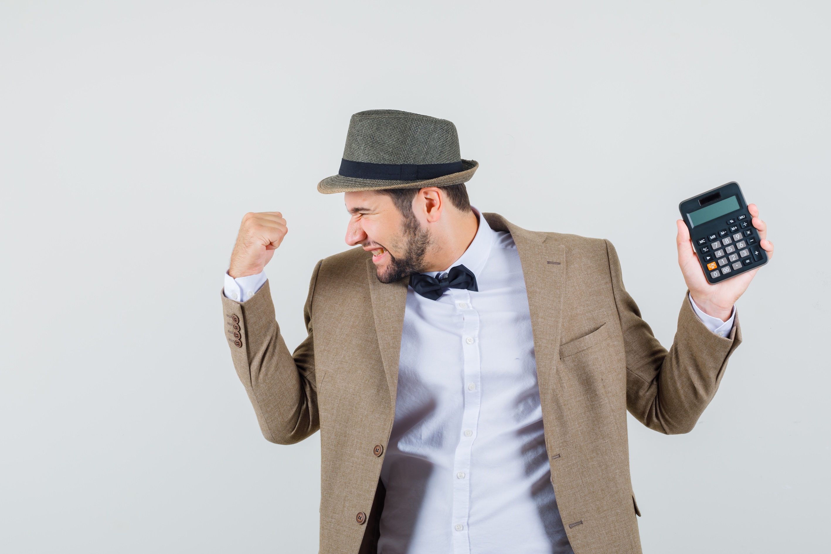 young_man_suit_hat_holding_calculator_with_winner_gesture_looking_happy_front_view