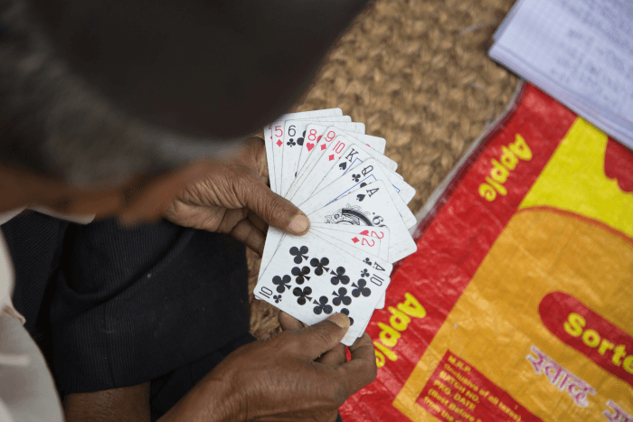 an old man holding a cards