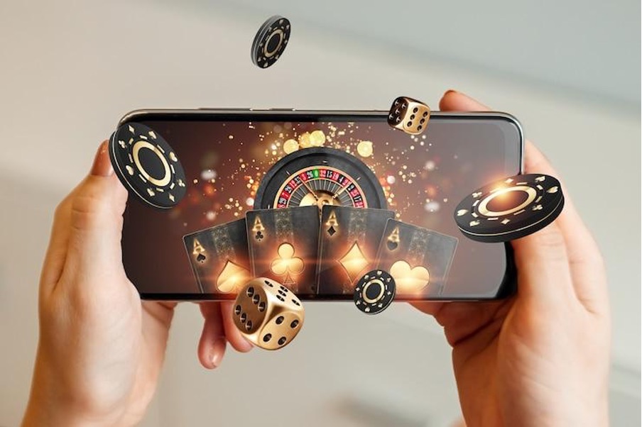 two hands holding a smart phone with ai imposed roulette wheel on screen and dice and chips appearing to float out
