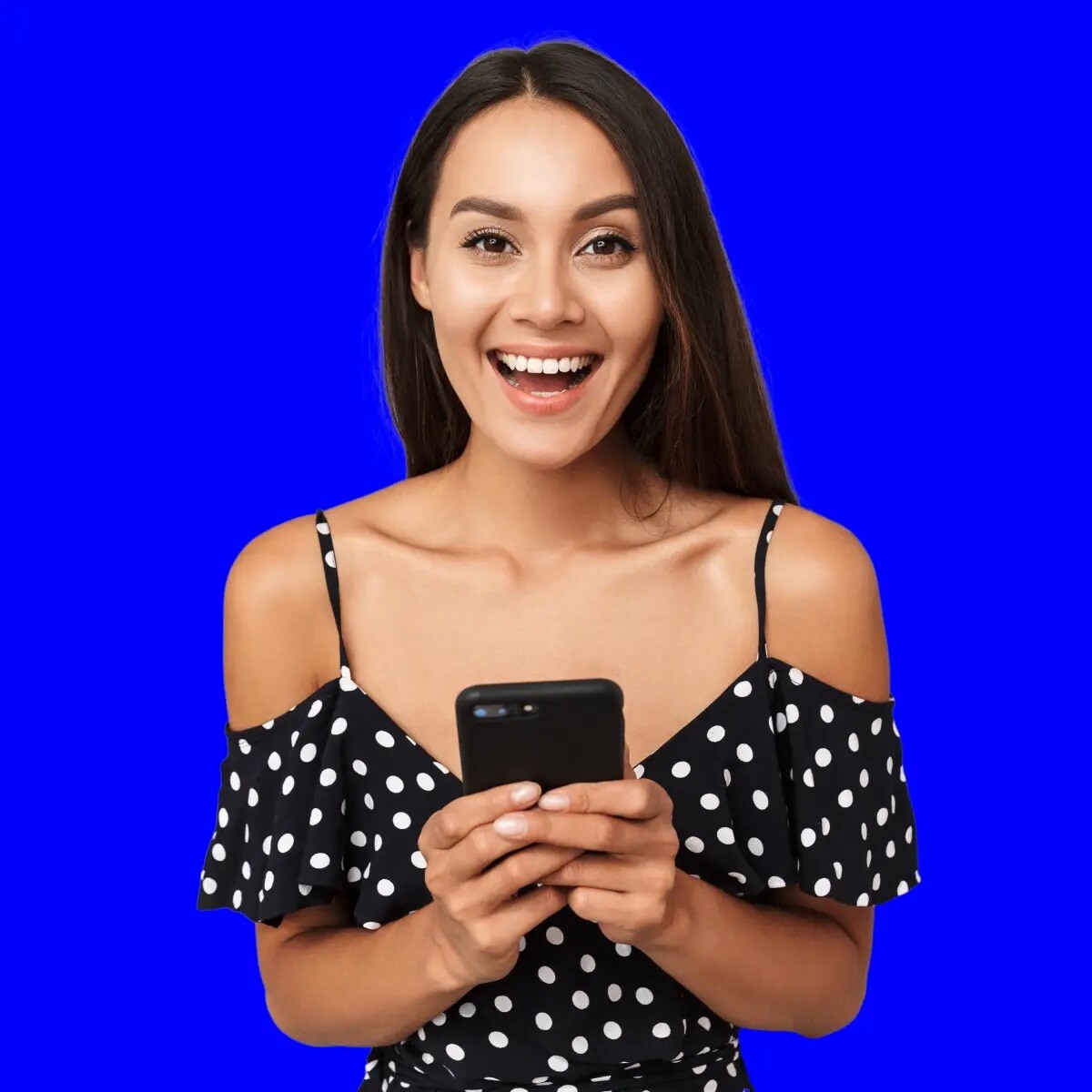 Smiling woman holding phone on royal blue background
