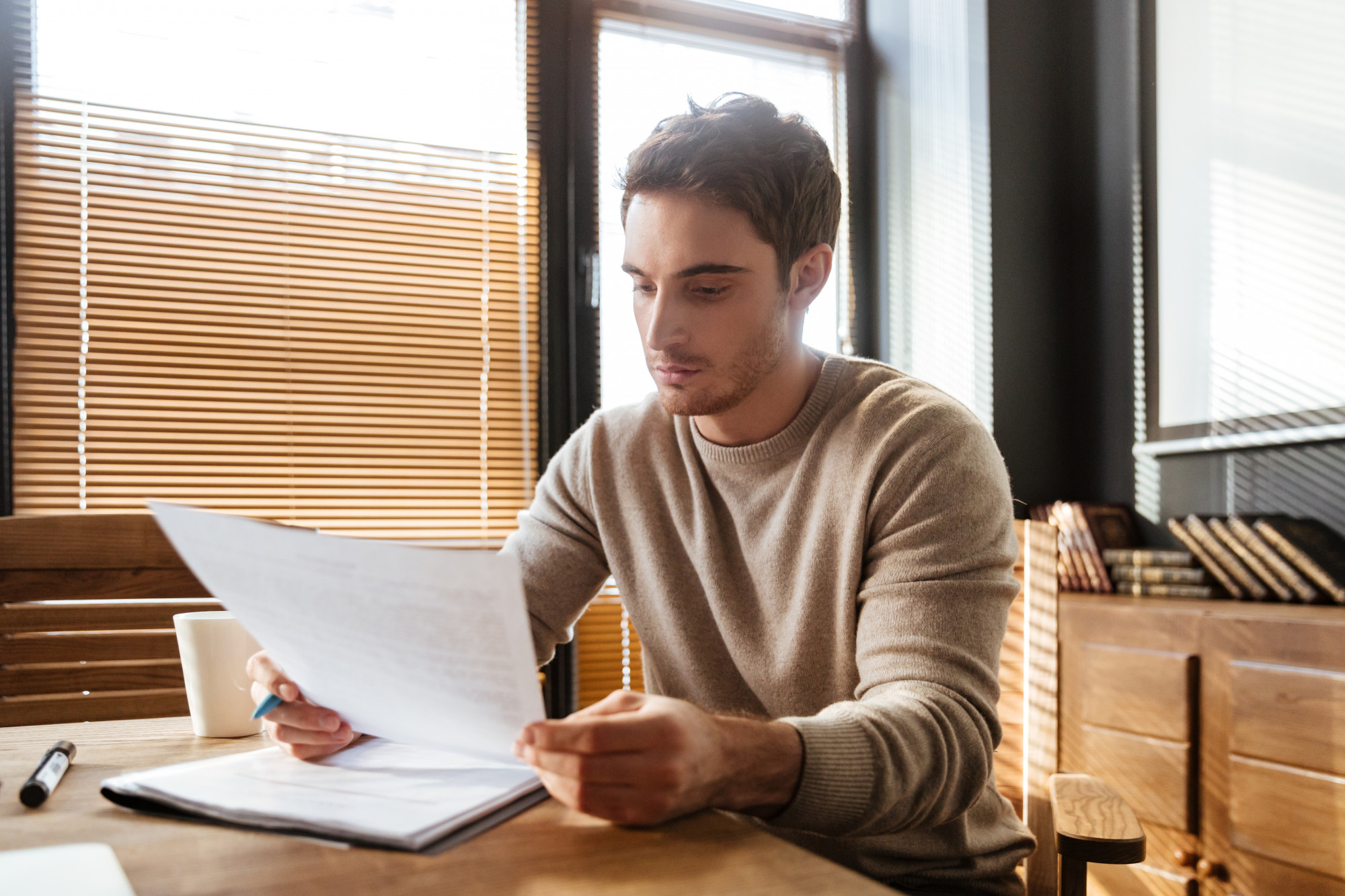 man looking at a paper
