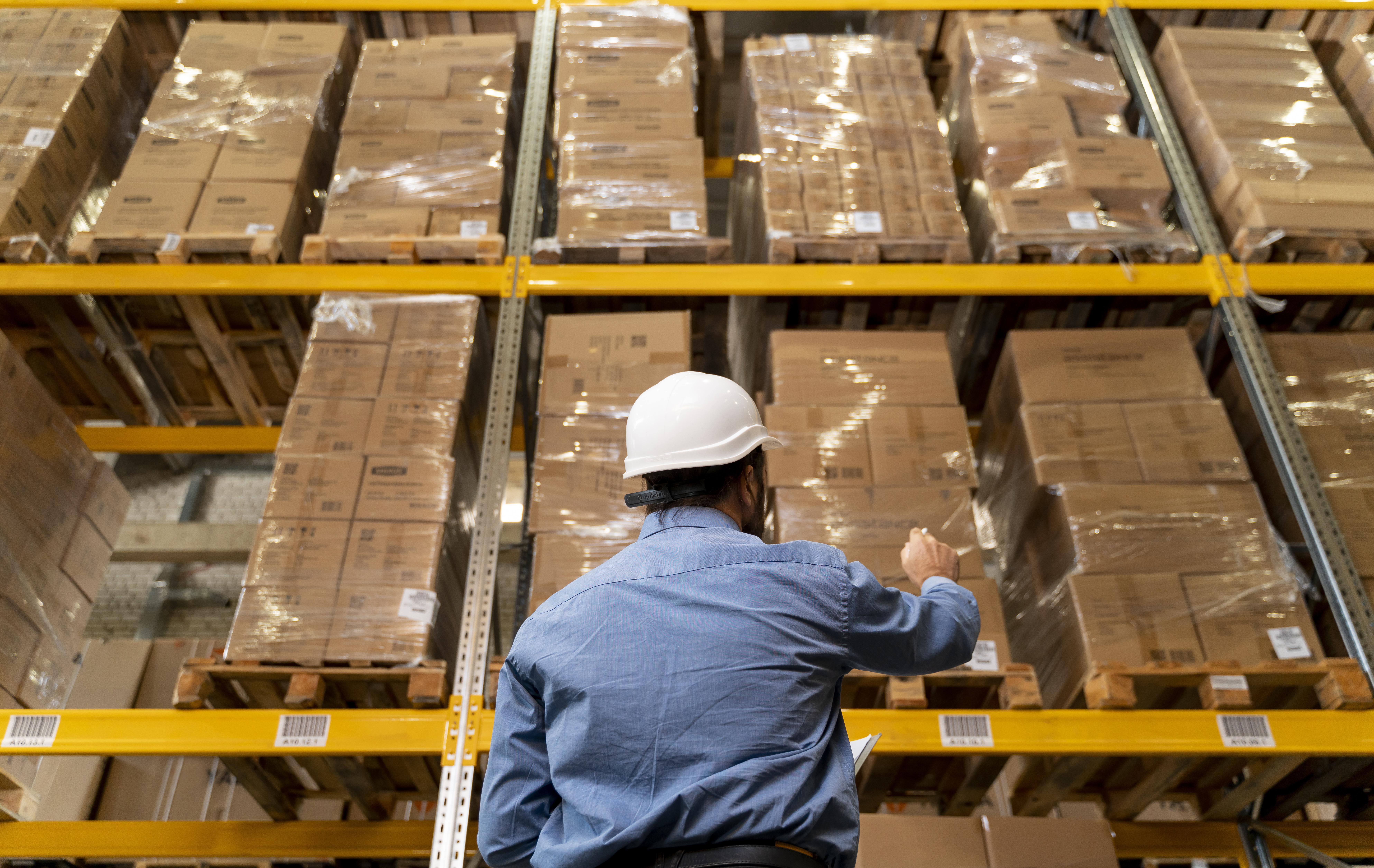 Man with helmet working in warehouse