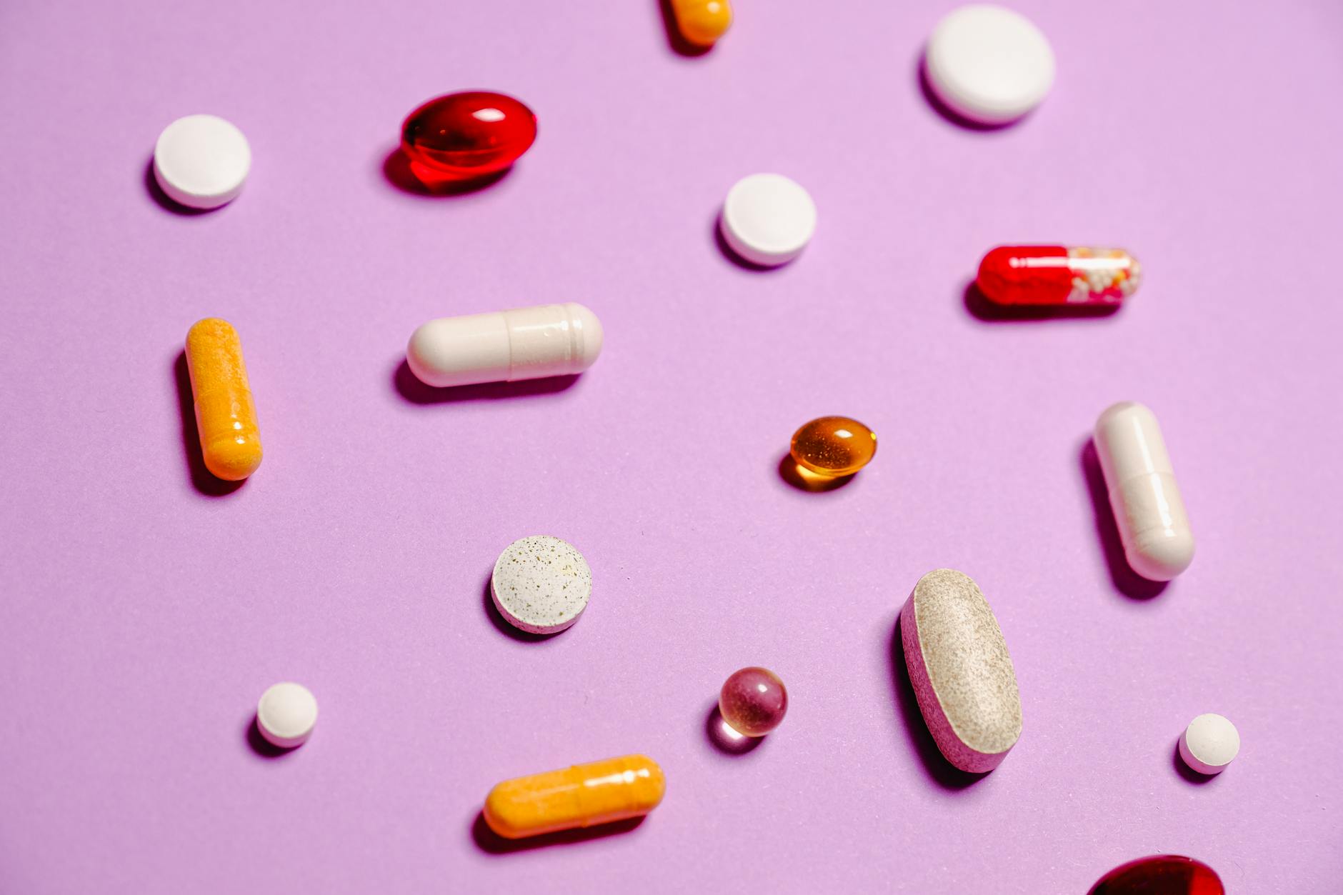 Multivitamins on a pink background