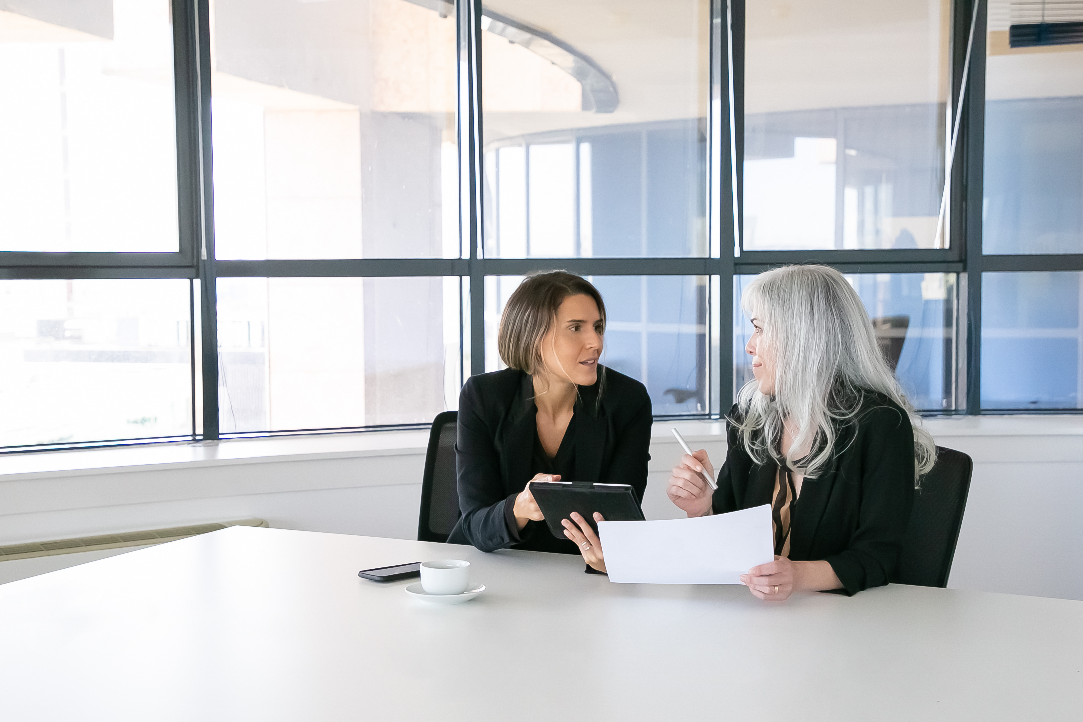 Two females discussing and analyzing reports