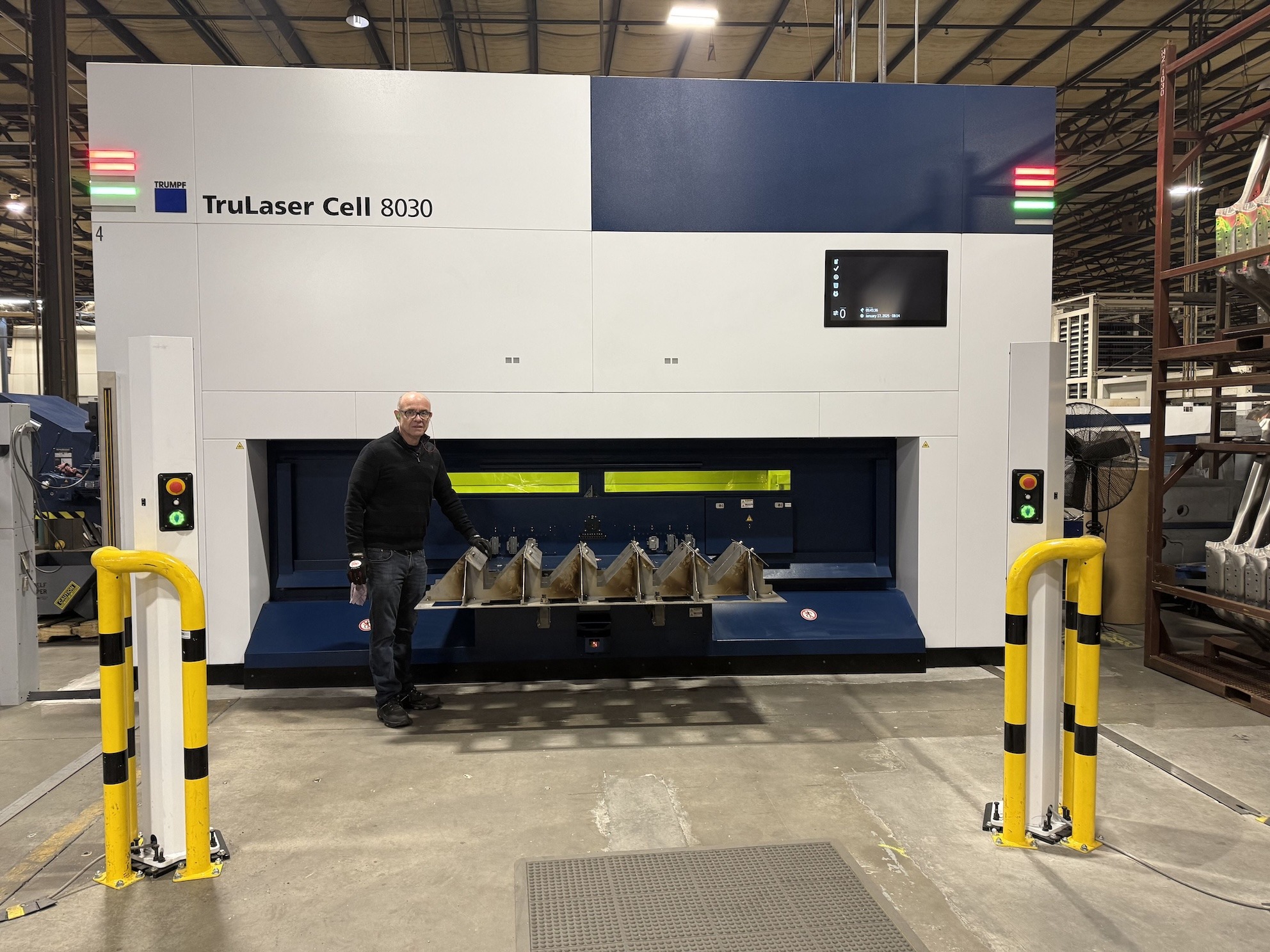 Photo of Engineer, Carlos Macias, standing in manufacturing facility where he is using AI to improve predictive maintenance and quality control