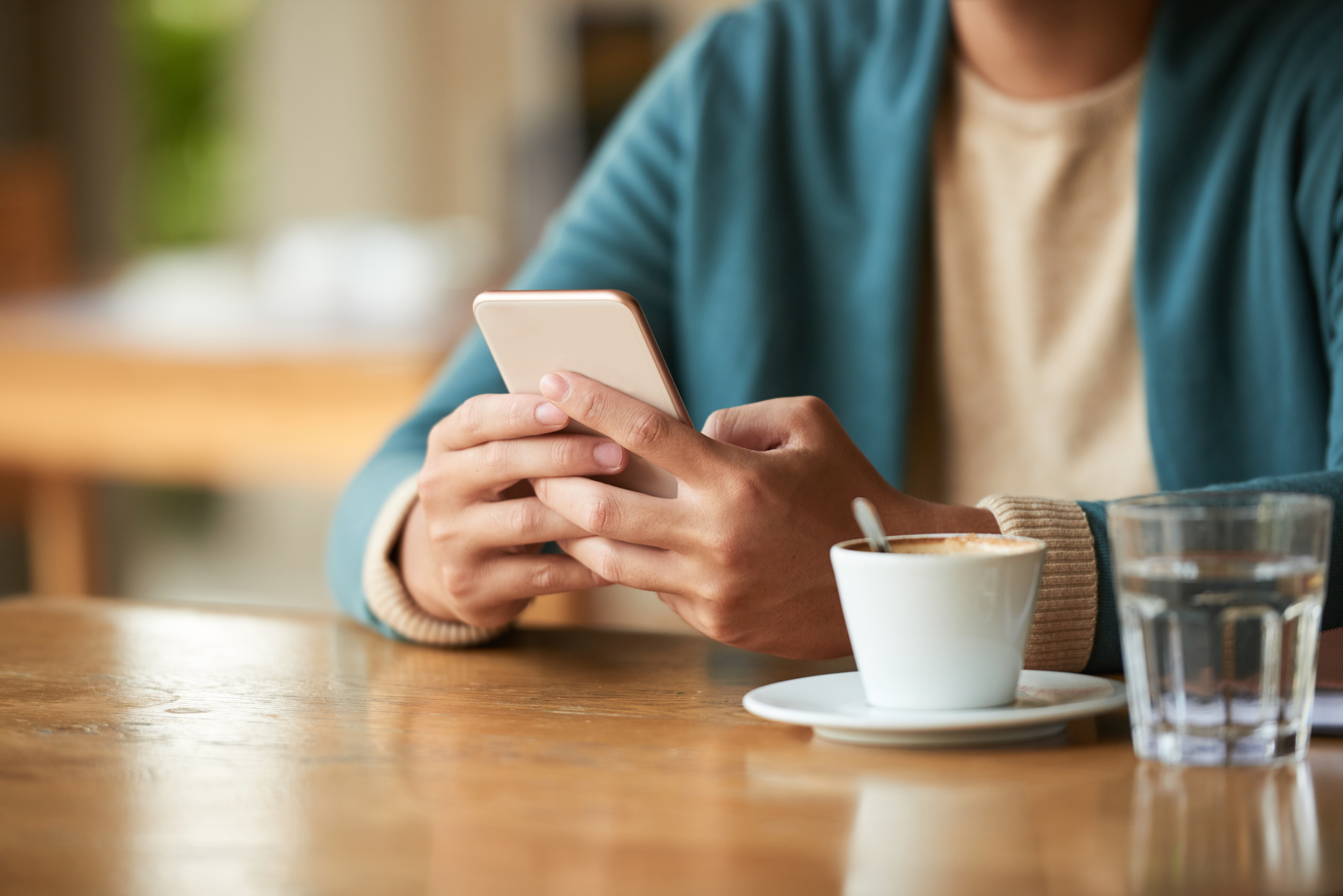 A property owner typing a message on a smartphone to communicate with guests.