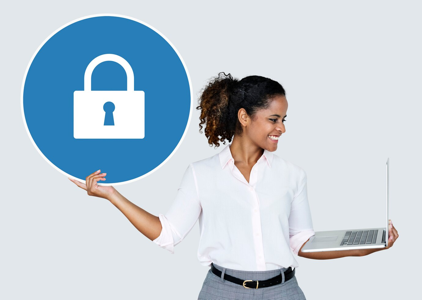 woman holding a laptop and a lock icon