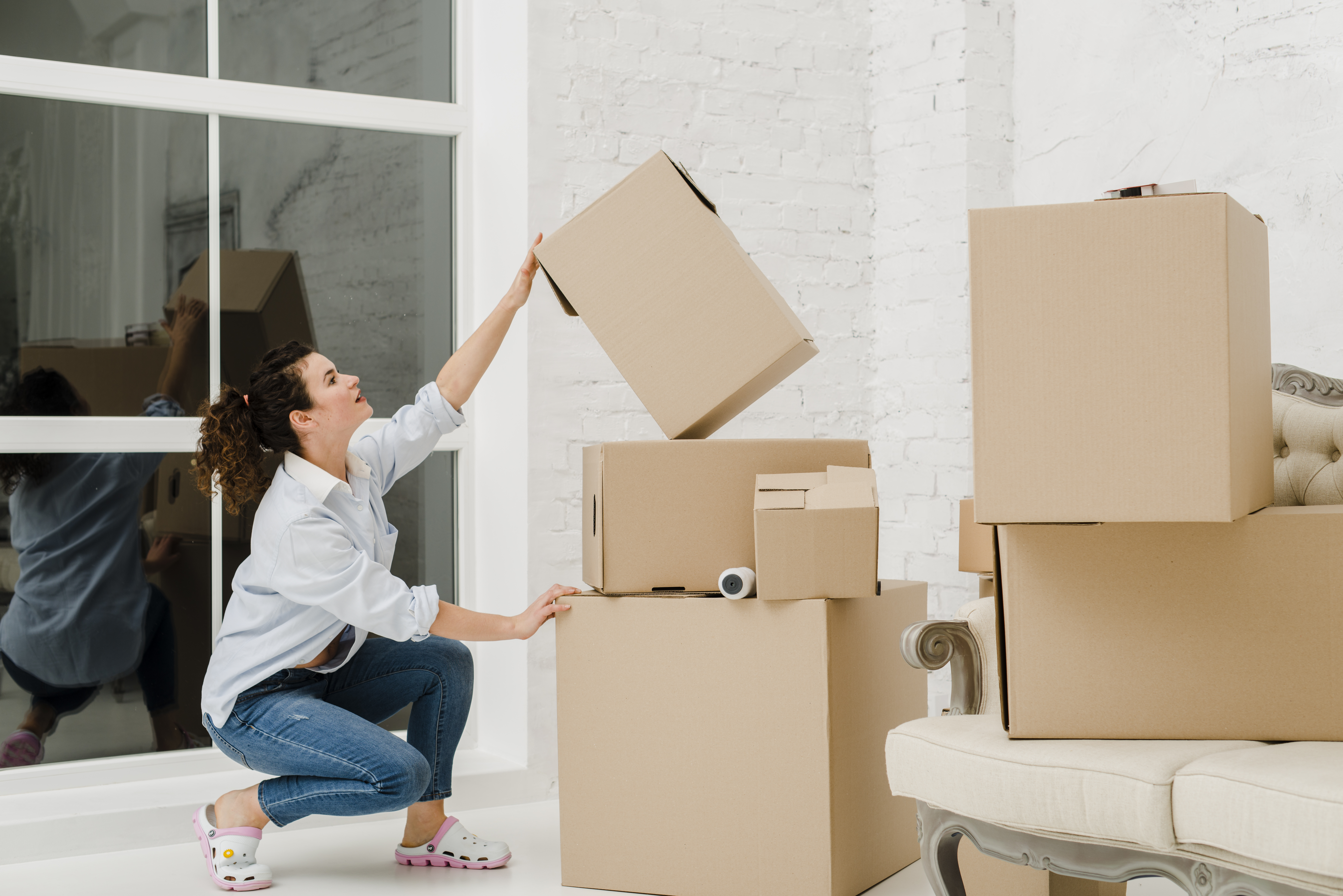 Woman sorting boxes after relocation